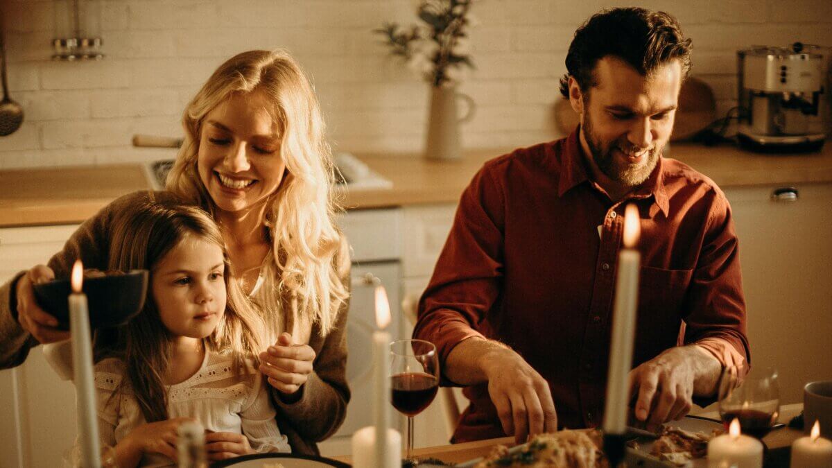 couple sitting at table with young daughter